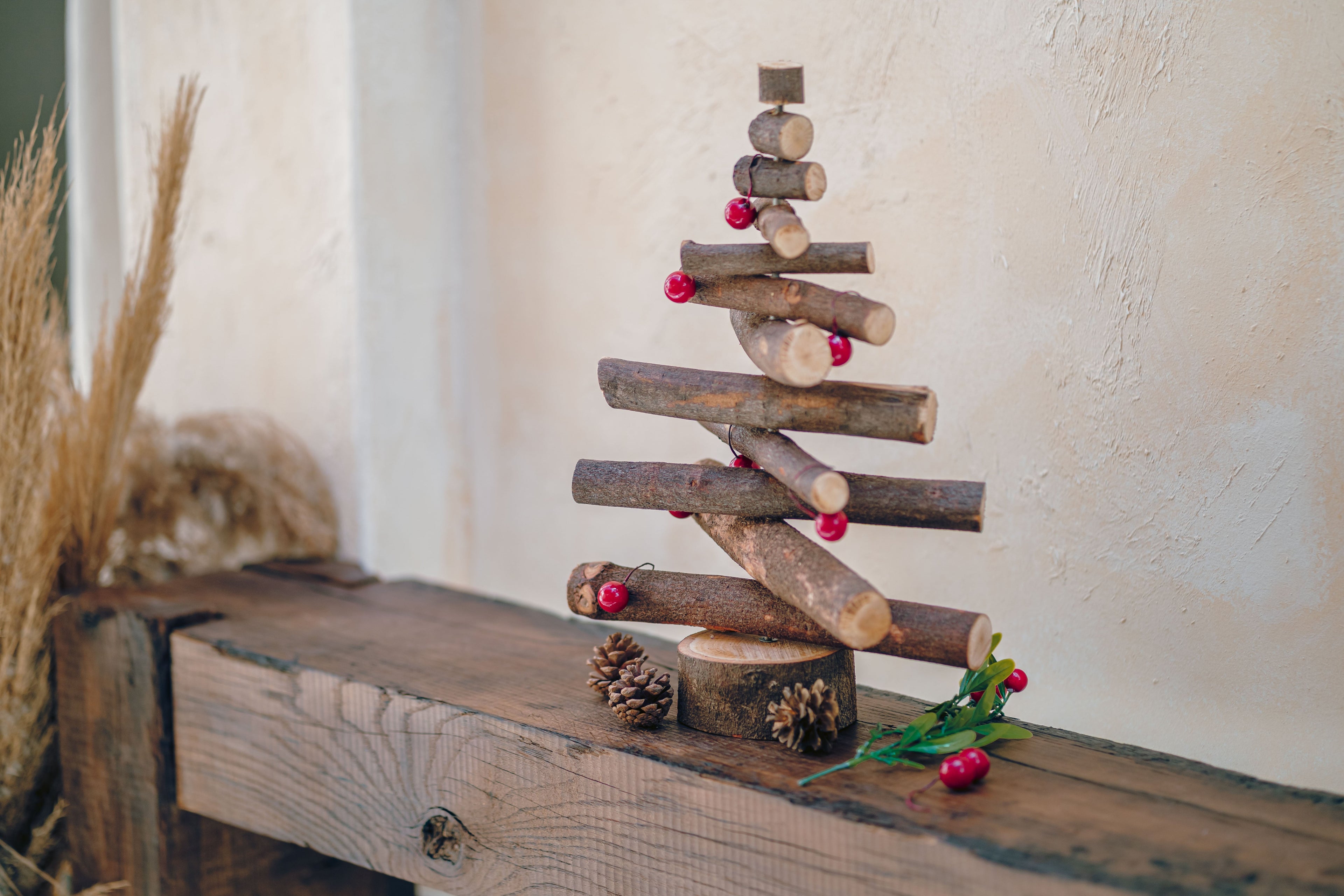 Wooden Christmas tree decoration on a rustic wooden surface with a neutral background